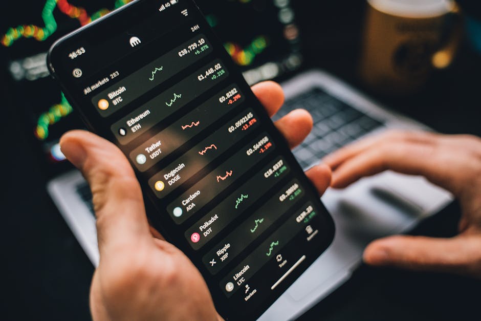 Person holding smartphone showing cryptocurrency market data, symbolizing digital investment tools